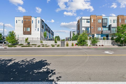 a view of an empty street with buildings on the side of the road